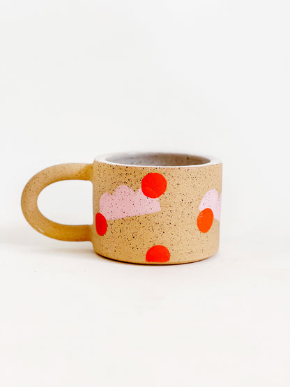 This handmade ceramic mug features playful polka dots over different shapes, adding a colorful and fun touch to your daily coffee or tea routine. Handcrafted with attention to detail, this unique mug is a must-have for any ceramic collection. Enjoy your favorite drink in a playful yet elegant way.